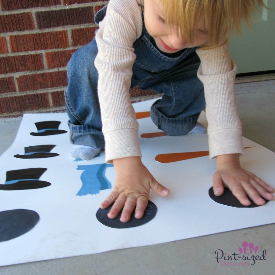 preschooler placing hands and feet on snowman game