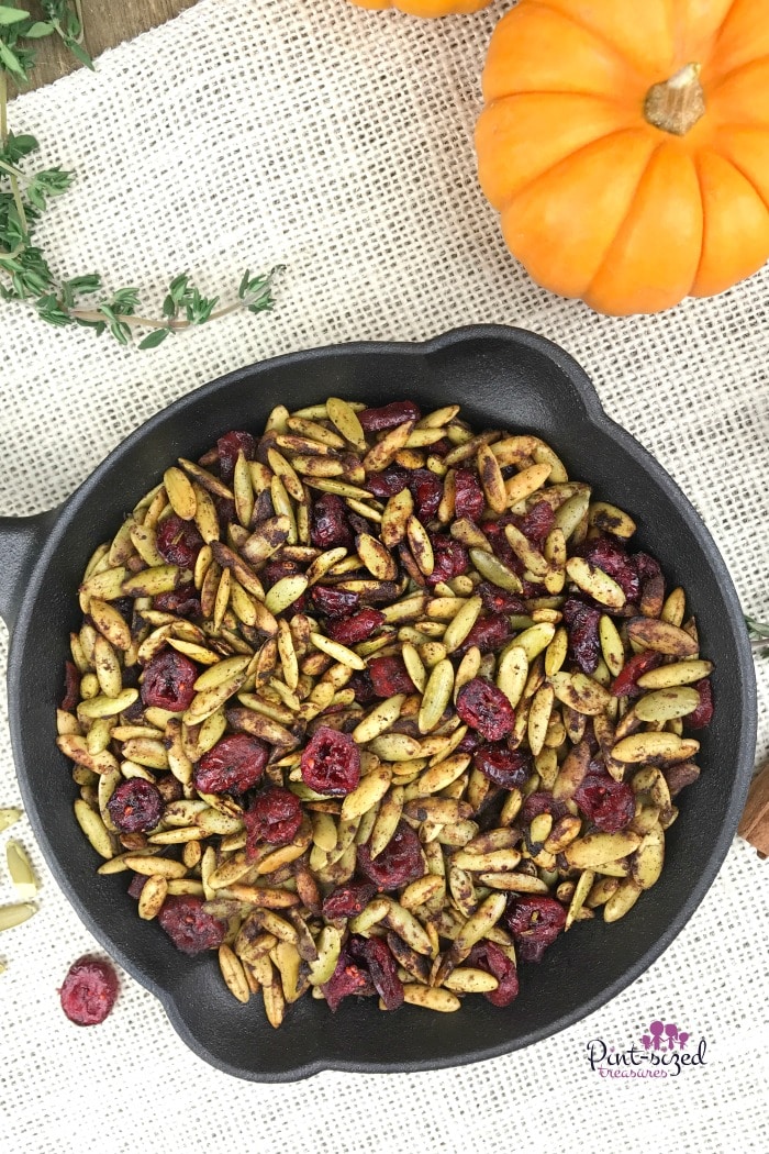 Oooh! These toasted pumpkin seeds with cranberries are a healthy, but indulgent snack for the holidays! It's perfectly spiced with your fave holiday spices and toasted to perfection. Enjoy pumpkin seeds in a whole new way!