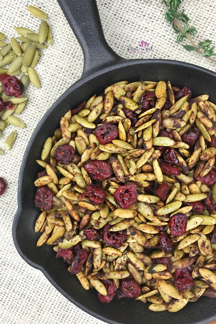 Oooh! These toasted pumpkin seeds with cranberries are a healthy, but indulgent snack for the holidays! It's perfectly spiced with your fave holiday spices and toasted to perfection. Enjoy pumpkin seeds in a whole new way!