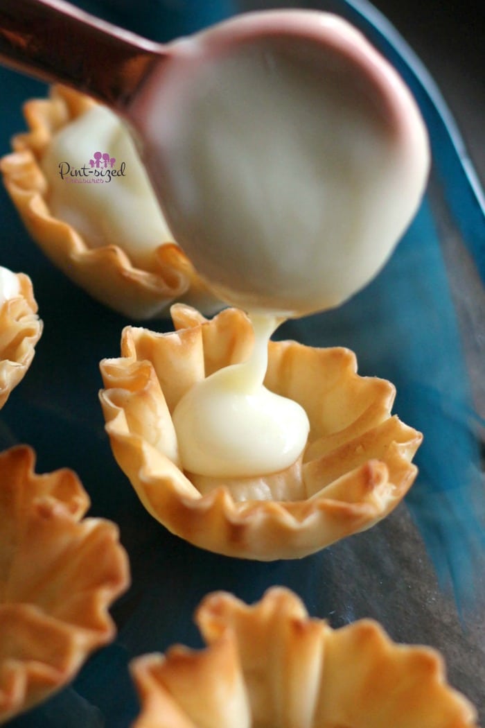 pouring the key lime pie mixture into the tarts