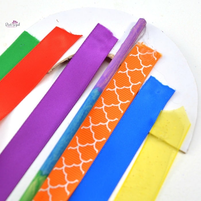 gluing ribbons on paper rainbow