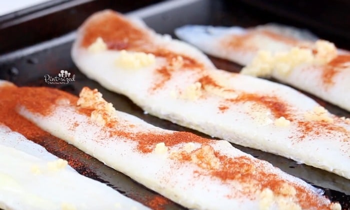 close-up of the easy baked fish being prepped for the oven