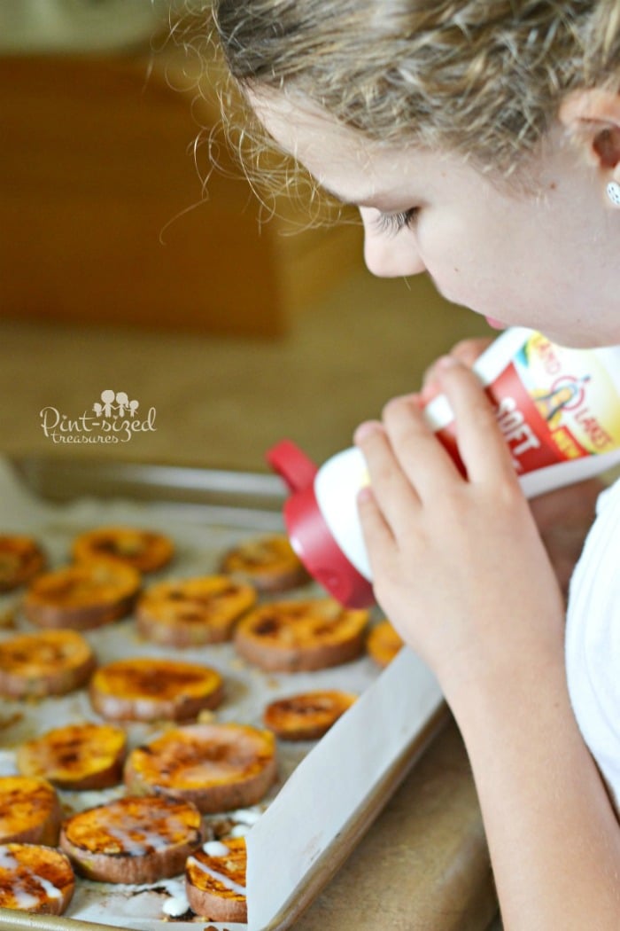 Drizzling the buttery spread onto the sweet potato bites