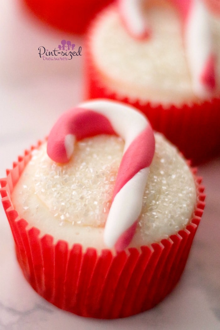 These adorable, candy cane cupcakes are made with fondant and are simple to create for the holidays! #candycanecupcakes #fondant 3fondantcupcakes #easyfondant #easycupcakes #holidaycupcakes #Christmascupcakes