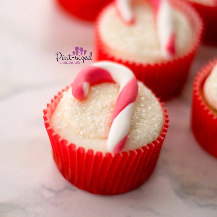 These adorable, candy cane cupcakes are made with fondant and are simple to create for the holidays! #candycanecupcakes #fondant 3fondantcupcakes #easyfondant #easycupcakes #holidaycupcakes #Christmascupcakes