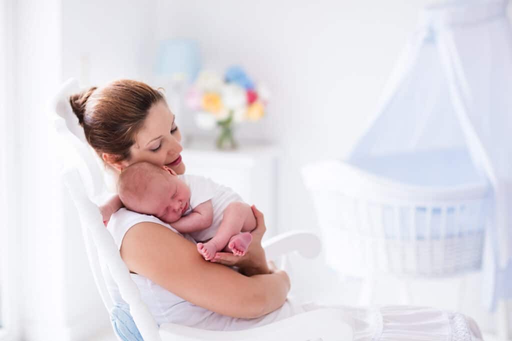 mom rocking a baby during a baby shower 