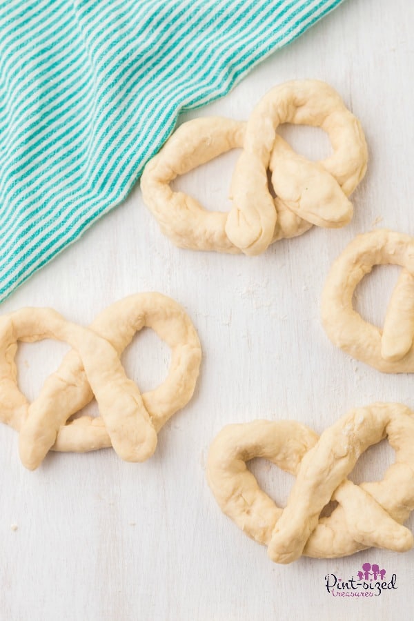 prepping homemade pretzels for baking