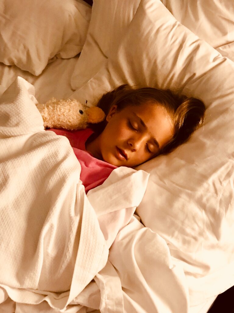 child sleeping in bed