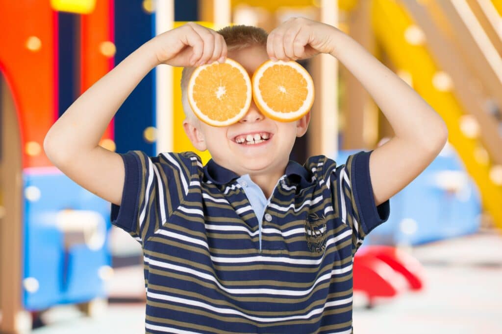 Silas holding up oranges