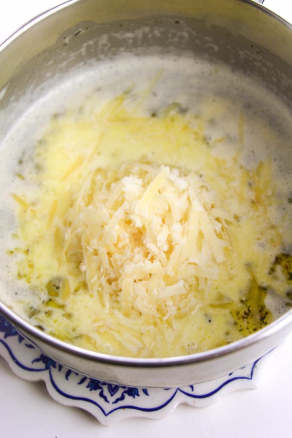 putting ingredients for Alfredo Sauce into pot