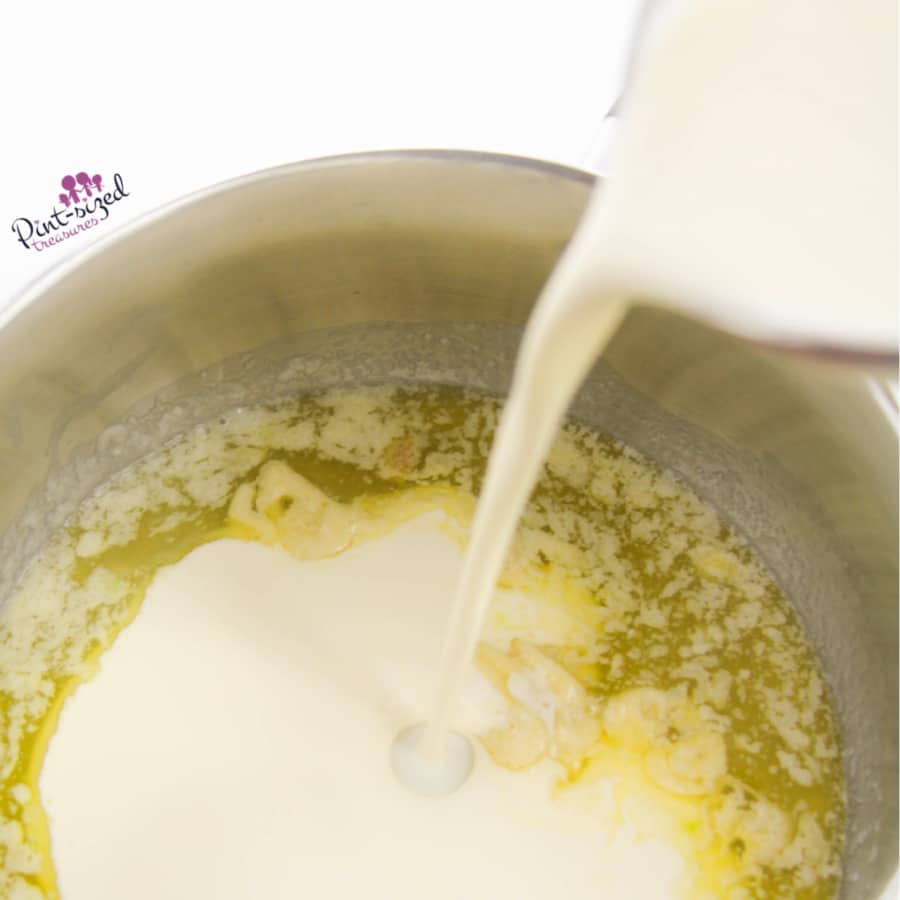 pouring whipping cream into the Alfredo Sauce