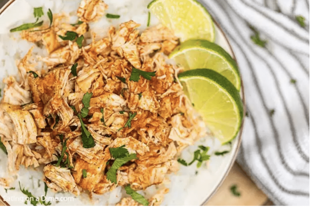 cilantro and lime slow cooker chicken being served on a white plate