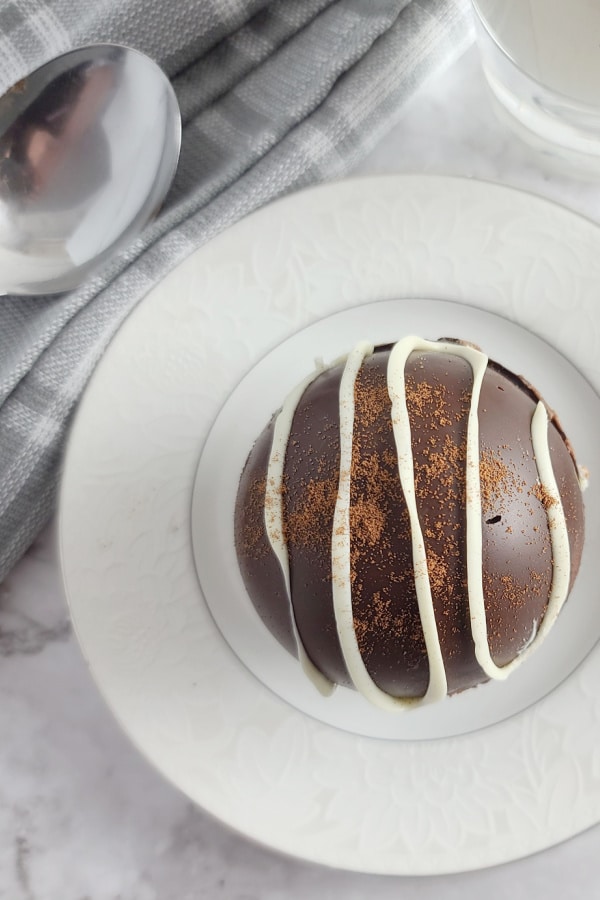 mocha hot chocolate bomb on white plate