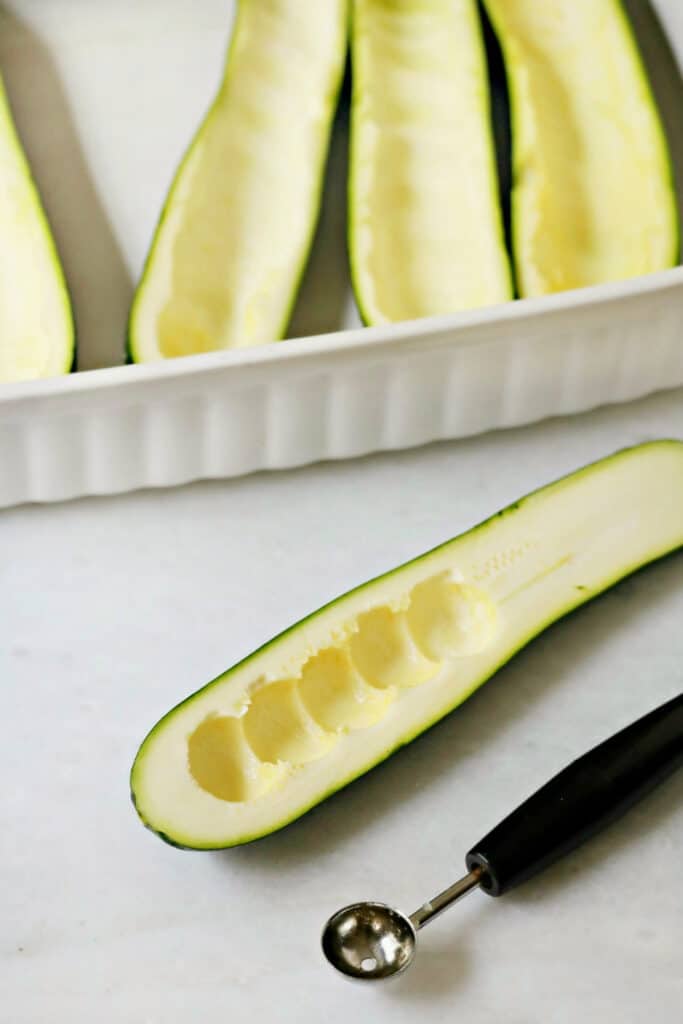 scooping out zucchini
