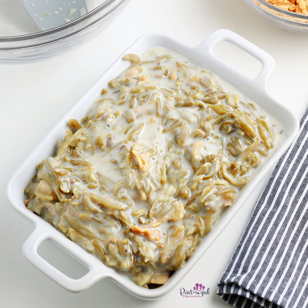 prepping the baking dish for the green bean casserole recipe