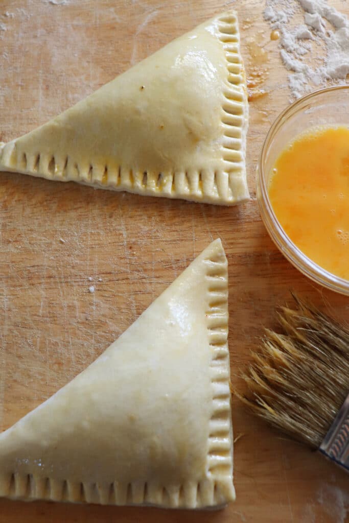 putting egg wash on pumpkin turnovers before baking