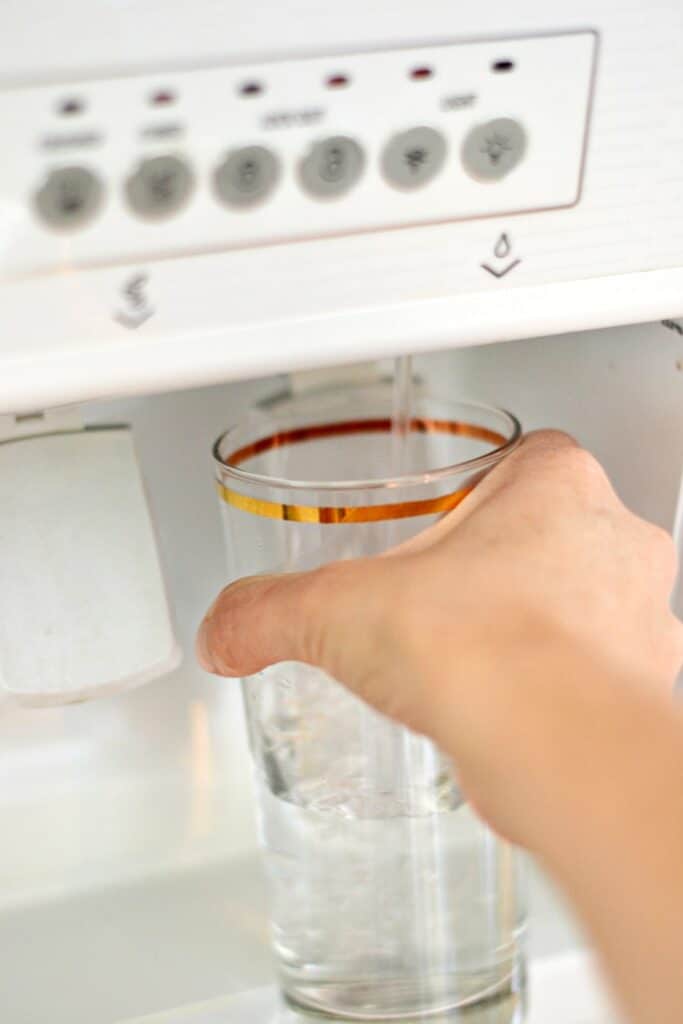 drinking water in a glass to save money while living on one income