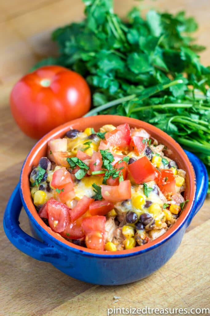 mexican lasagna in blue serving dish