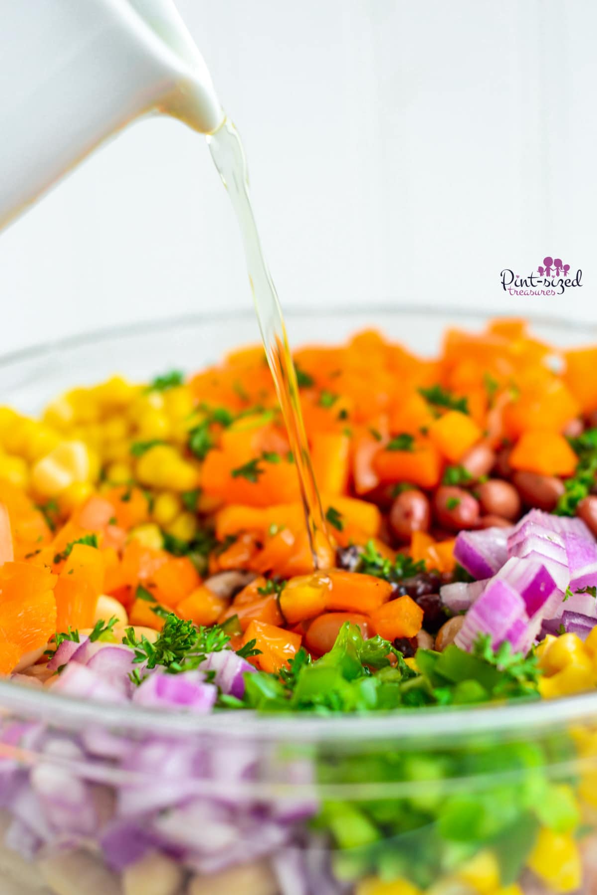 pouring homemade dressing over cowboy caviar