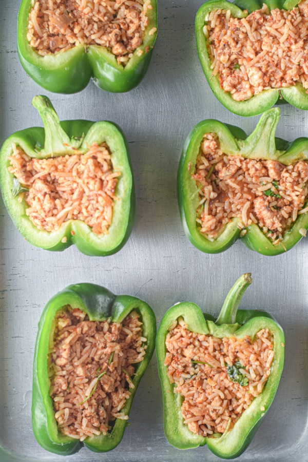 adding rice to green peppers for stuffed peppers