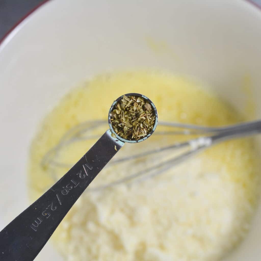 whisking cheeses and spices for pizza spaghetti casserole