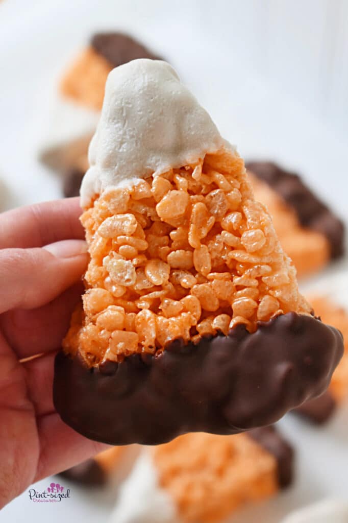 holding a chocolate covered candy corn Rice Krispie treat